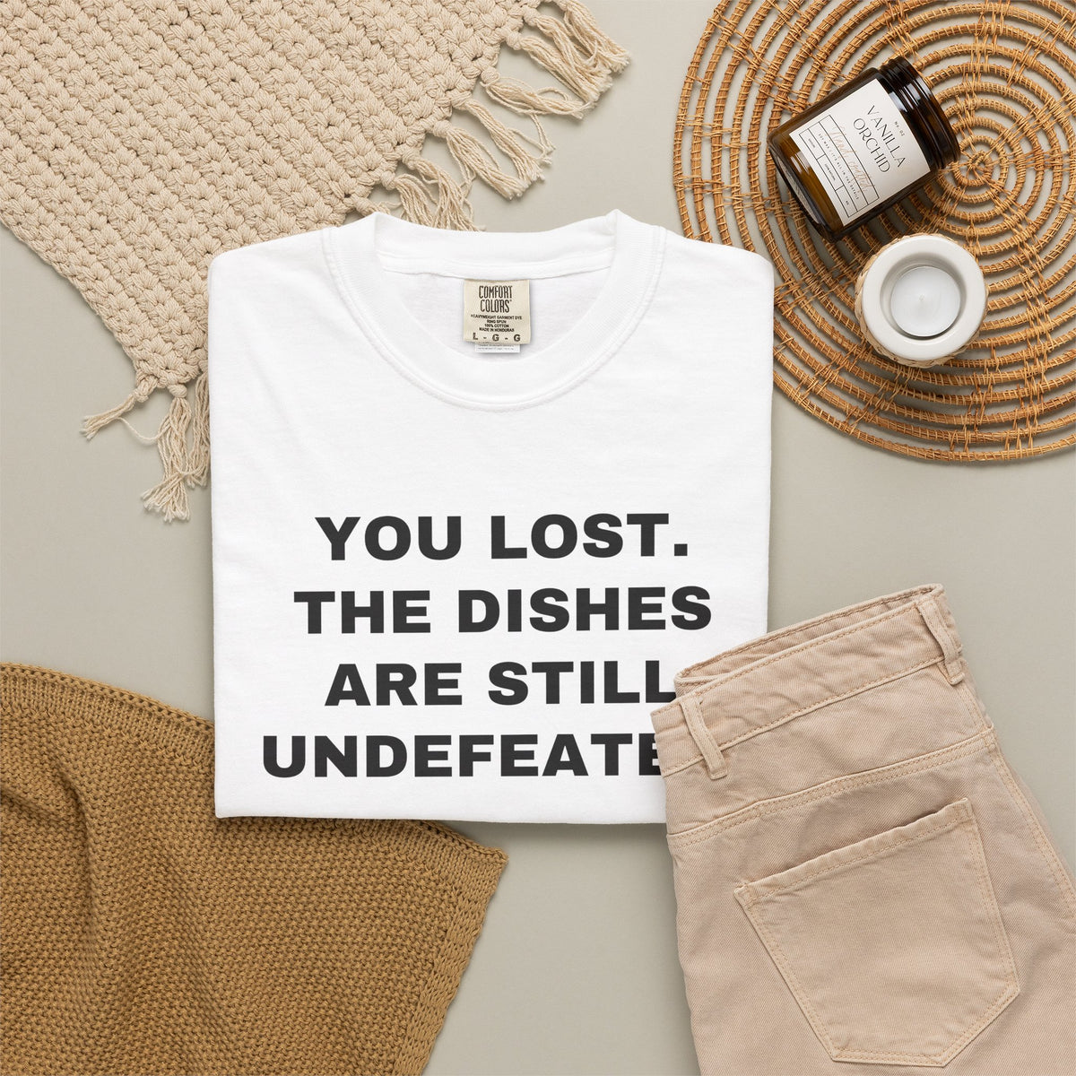 White shirt flat lay showing the front rivalry slogan.